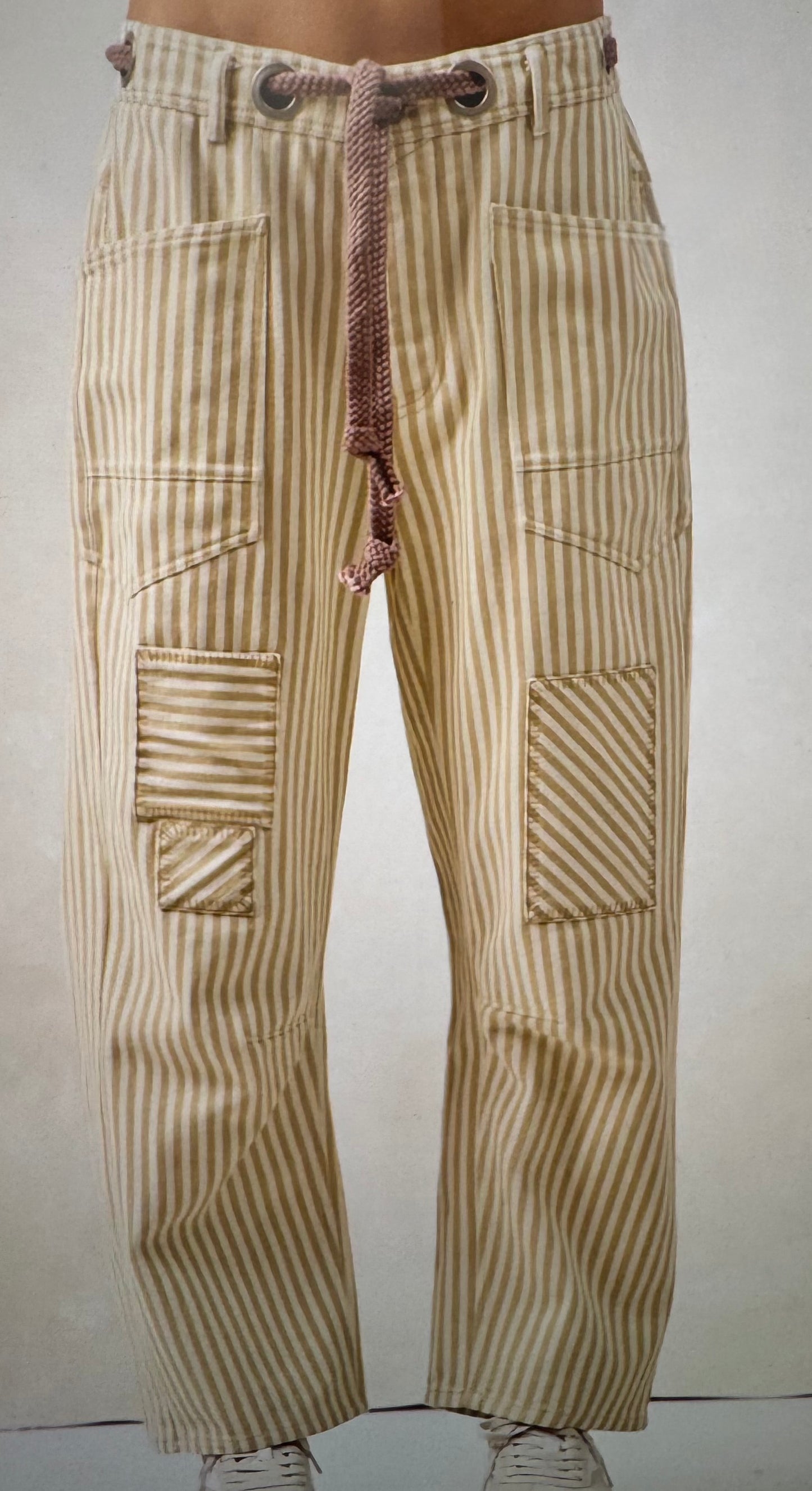 Beige striped cargo pants on a plain background barrel jeans