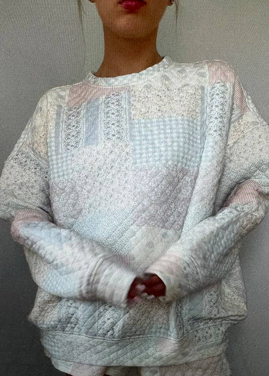 Person wearing a textured sweater with a neutral background