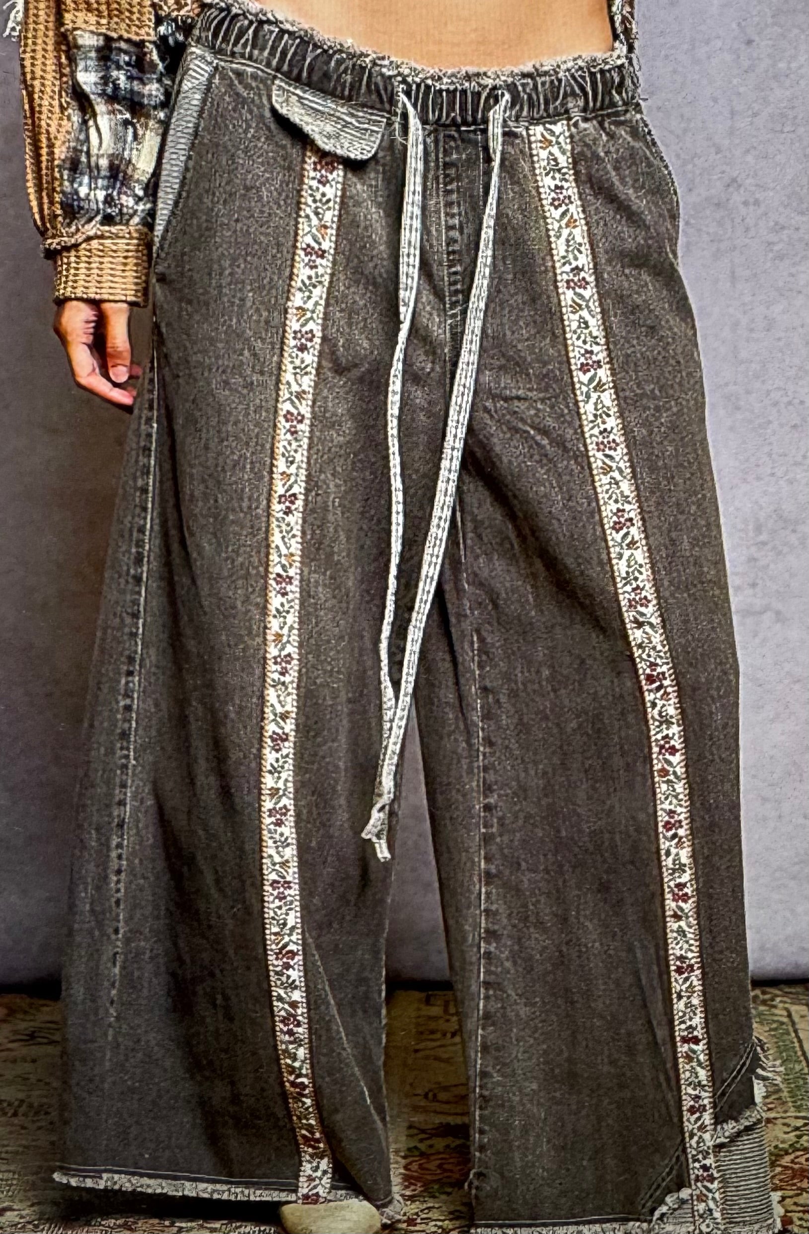 gray pants with loral accents and drawstring