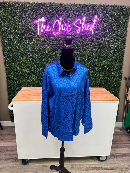 Blue patterned garment on a mannequin in front of a green wall with 'The Chic Shed' sign.