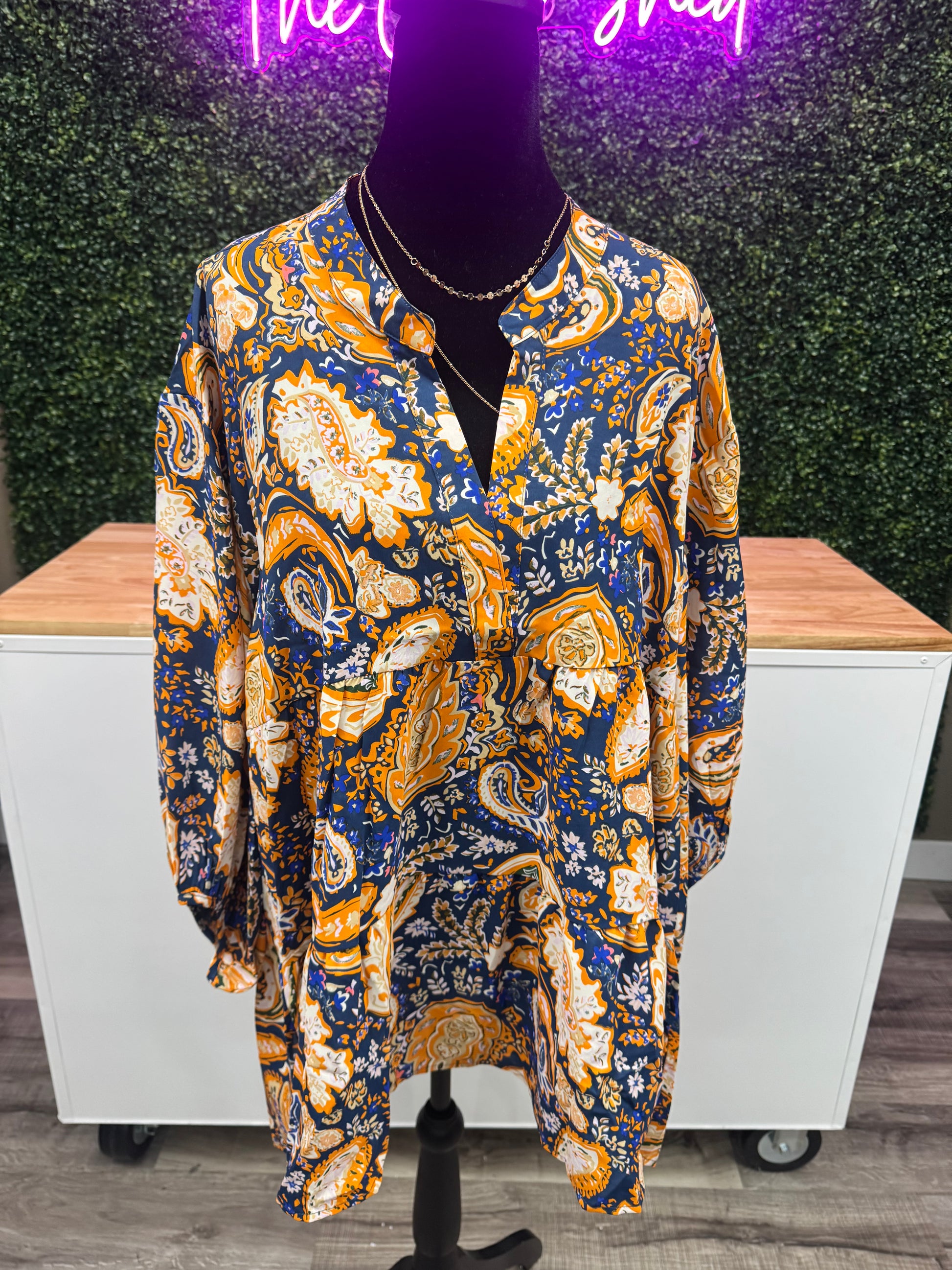 Patterned fabric draped over a wooden surface with a blurred background