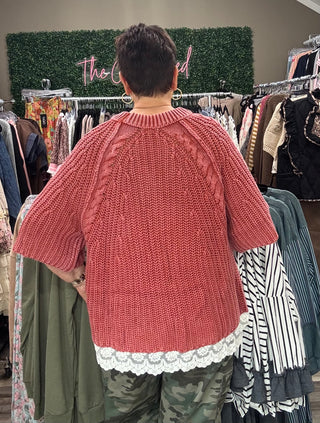 Rose/rust short sleeve sweater withRose/rust short sleeve sweater with lace trim on the bottom on model in store