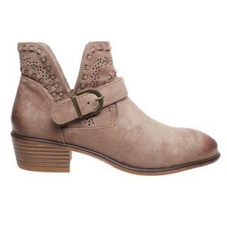 A taupe-brown suede ankle boot with a block heel, a decorative strap across the instep with a metal buckle, and perforated detailing on the collar, shown against a plain white background.