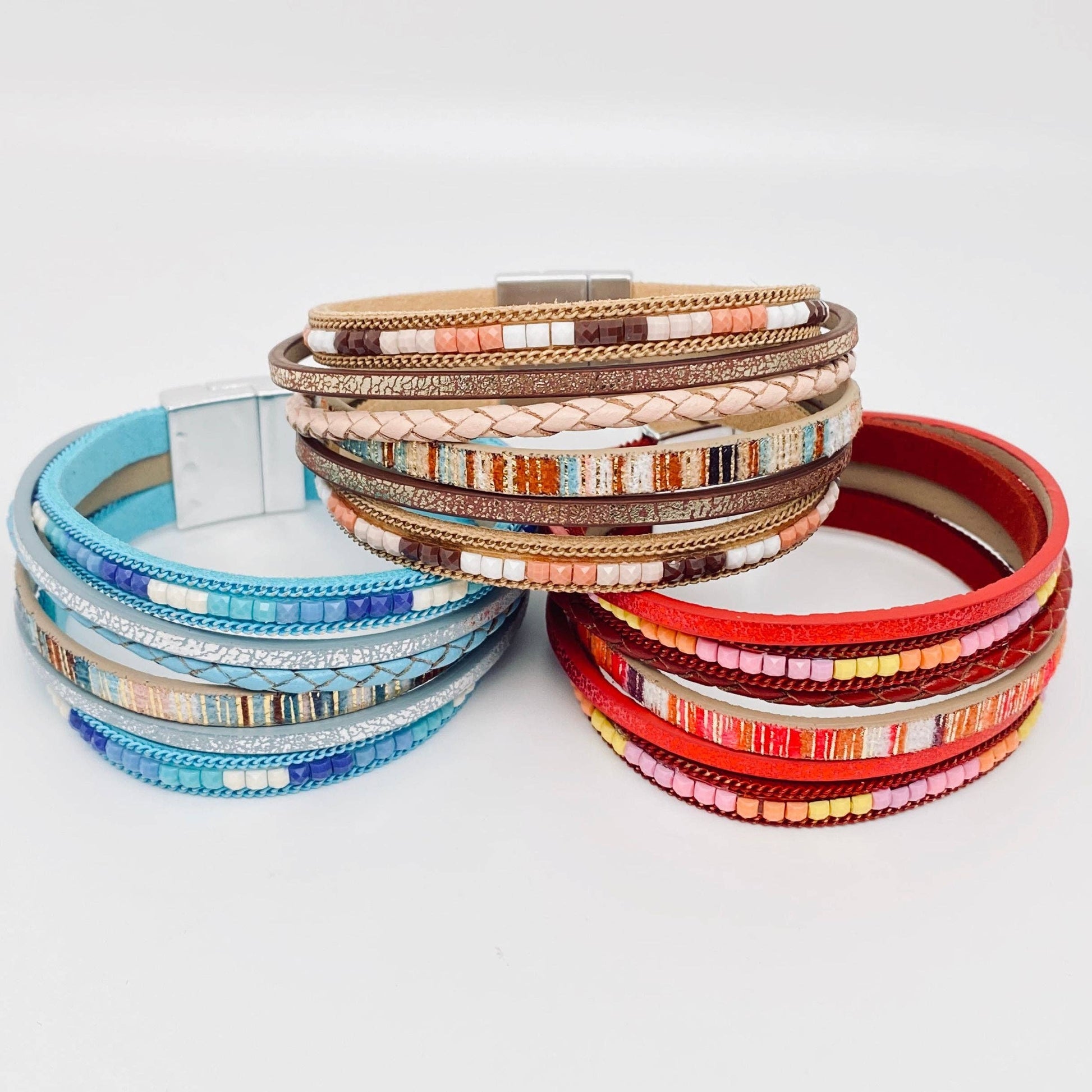 Stack of colorful bracelets on a light gray background